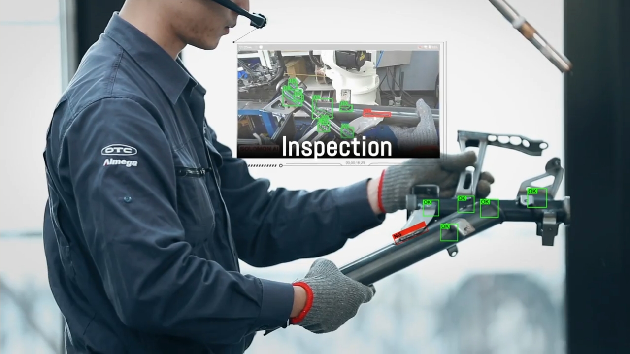 an engineer wearing a hardhat and AR glasses inspects a metal frame using META-aivi