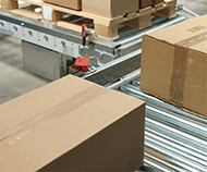 cardboard boxes on a conveyor inside a distribution center