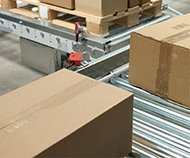 cardboard boxes on a conveyor inside a distribution center