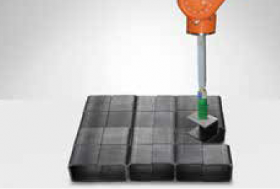 densely packed black blocks are picked by a robot arm suction gripper