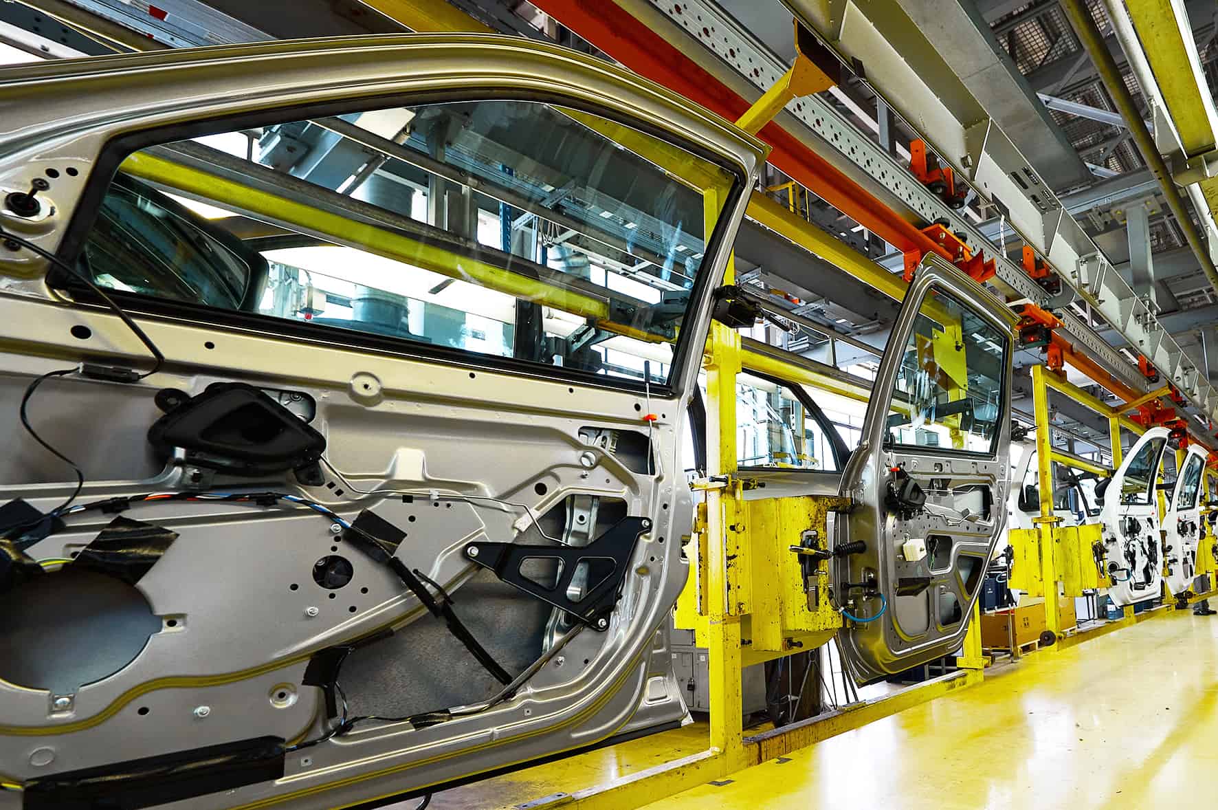 Car doors painted shiny gray color in assembling workshop