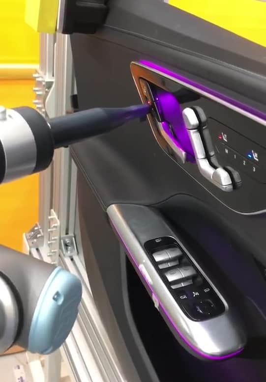 car door on automotive assembly line inspected by UR robot arm