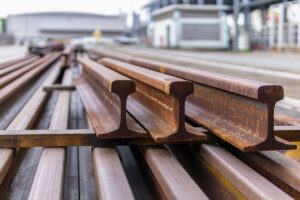 metal rails stacked in a railway yard