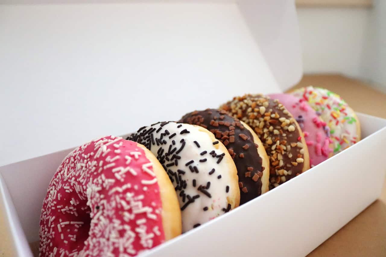 Doughnuts iced ring doughnuts in a white box