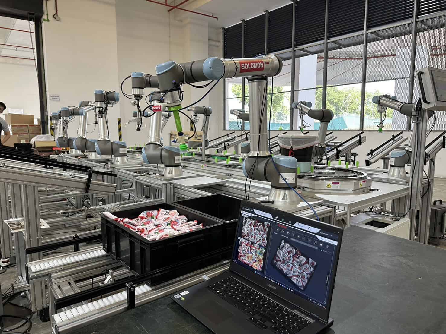 Navigazione del Robot sistema di imballaggio automatizzato con 10 UR cobot e il software AccuPick per il picking da contenitori