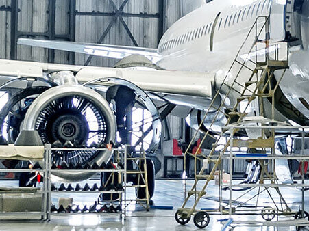 a new commercial aircraft airframe being assembled in a hangar