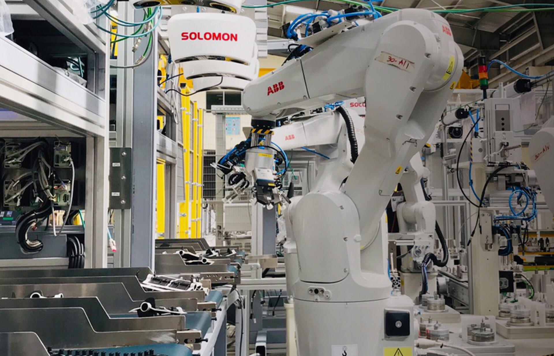 an ABB robot on an assembly line arm conducts a kitting task