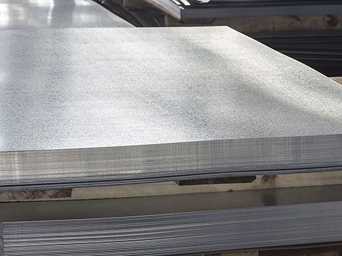 a stack of metal sheets on top of a metal table