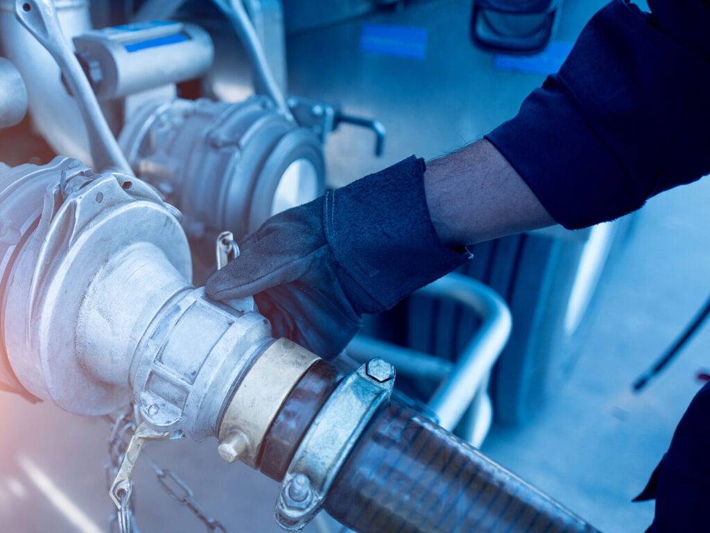 a man checking fuel truck pipeline