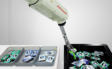 robot arm classifying and sorting packets of chewing gum