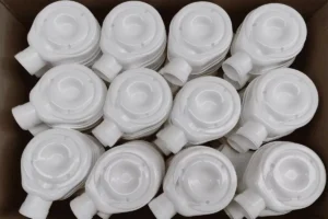 Plastic sanitary equipment parts arranged in a semi-structured bin for AccuPick 3D bin picking.