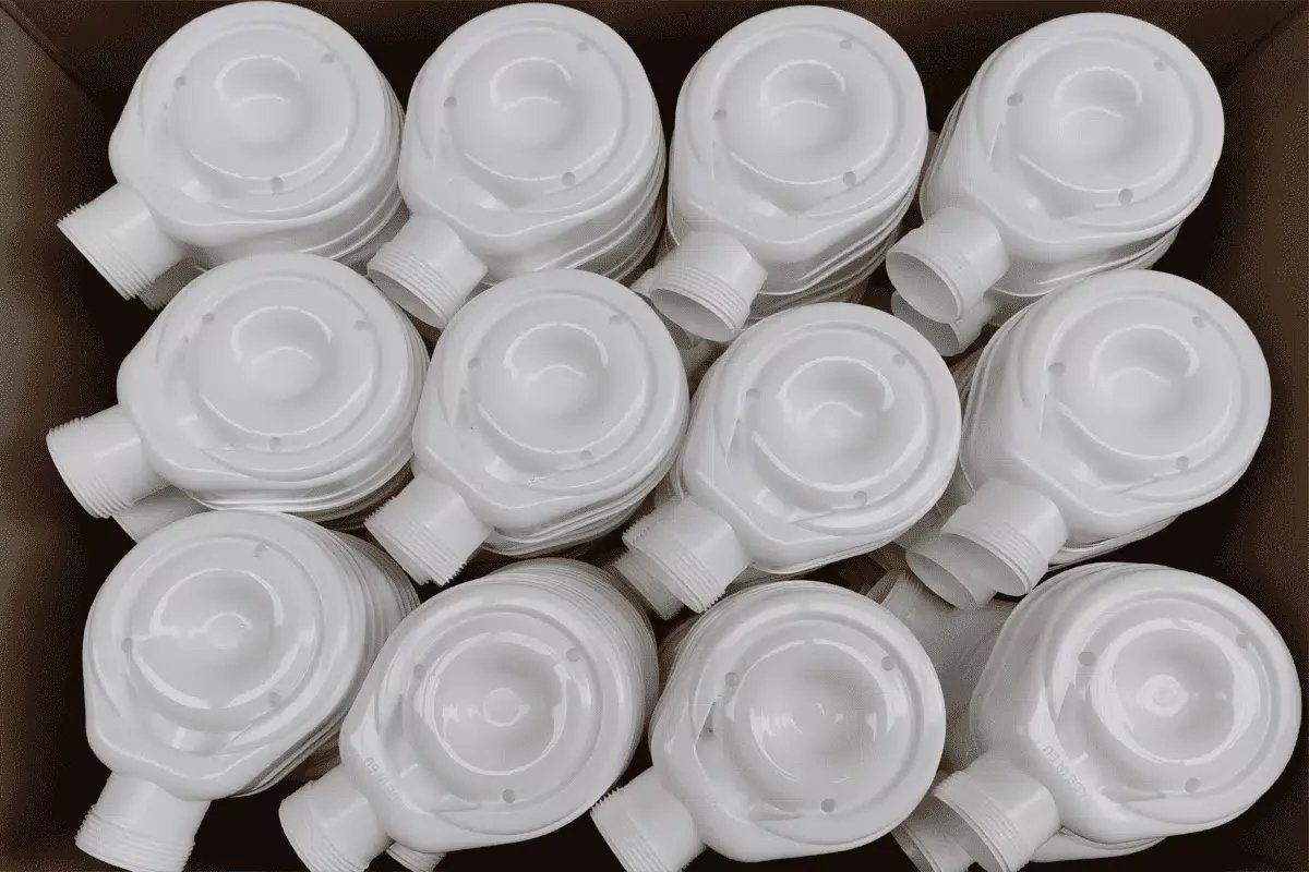 Plastic sanitary equipment parts arranged in a semi-structured bin for AccuPick 3D bin picking.