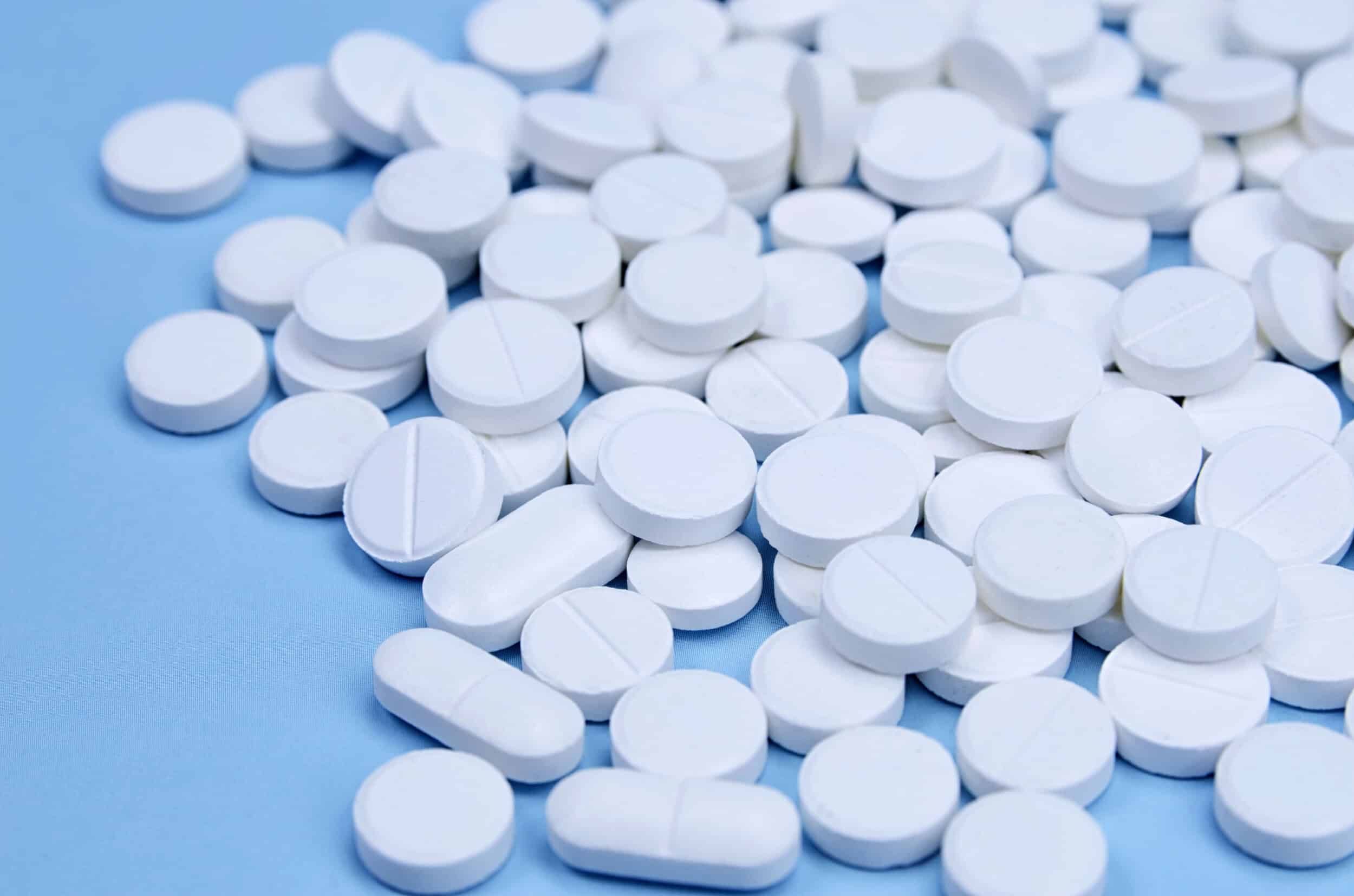 White pharmaceutical tablets prepared for AI tablet inspection during production quality control.