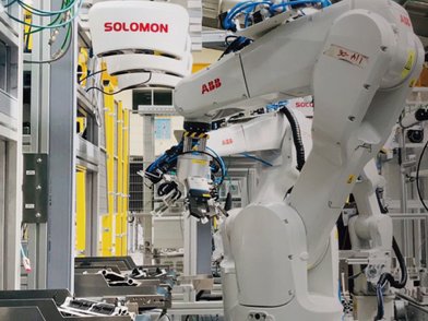 Automated kitting by an ABB robot using a SolScan 3D camera and AccuPick AI vision software to accurately pick and place components onto an industrial assembly line tray.