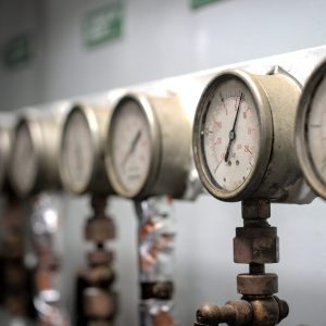 Pressure gauge psi meter in pipe and valves of water, oil and gas system industry