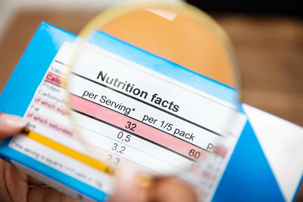 Magnified nutrition label illustrates the inspection of printed text and information on food packaging.