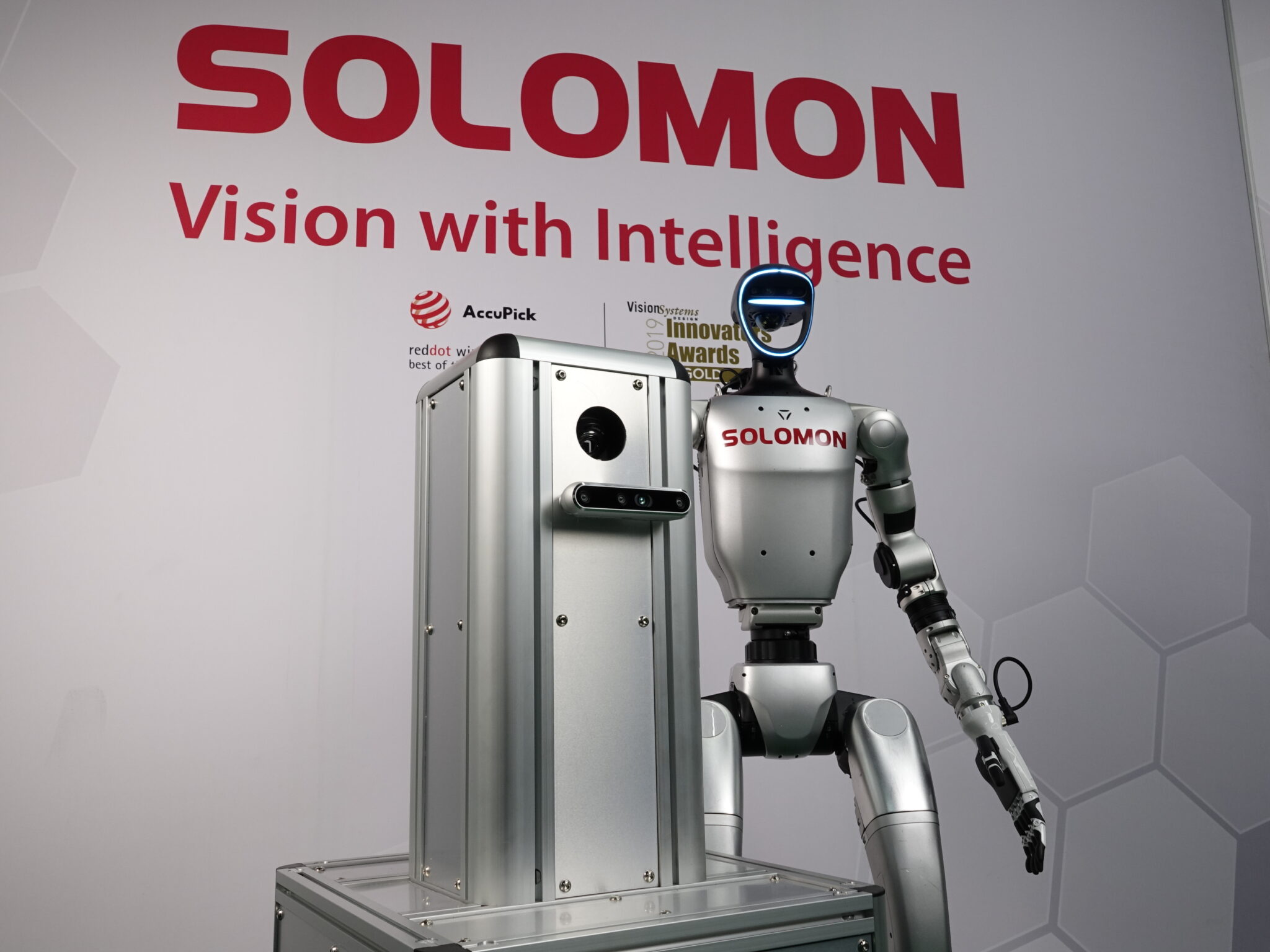 Sora x Supereye Humanoid Robot Solomon humanoid robot with AI vision and an AMR in front of the Solomon logo and slogan in a warehouse.