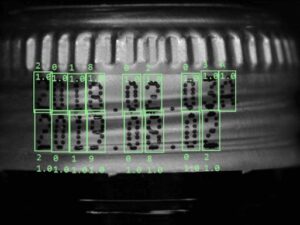 AI-based bottle cap inspection and OCR system verifying batch and date codes on aluminum caps in high-speed production lines.