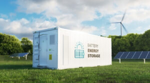 An energy storage system (ESS) in a park surrounded by trees, solar panels, and an wind turbine